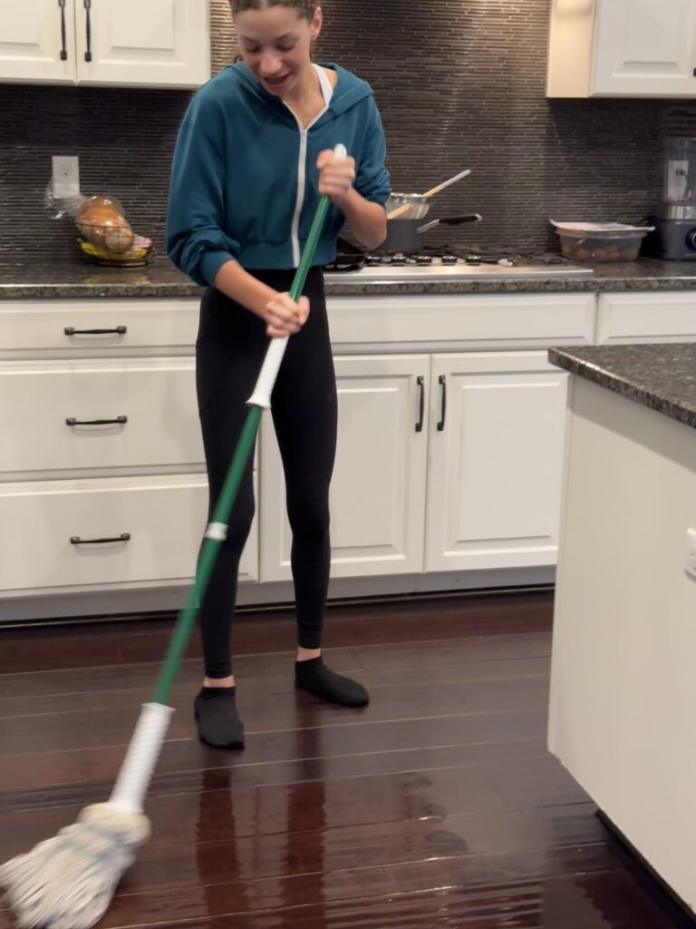 teenager mopping the floor