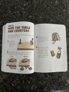 book open to the chapter on wiping the counters